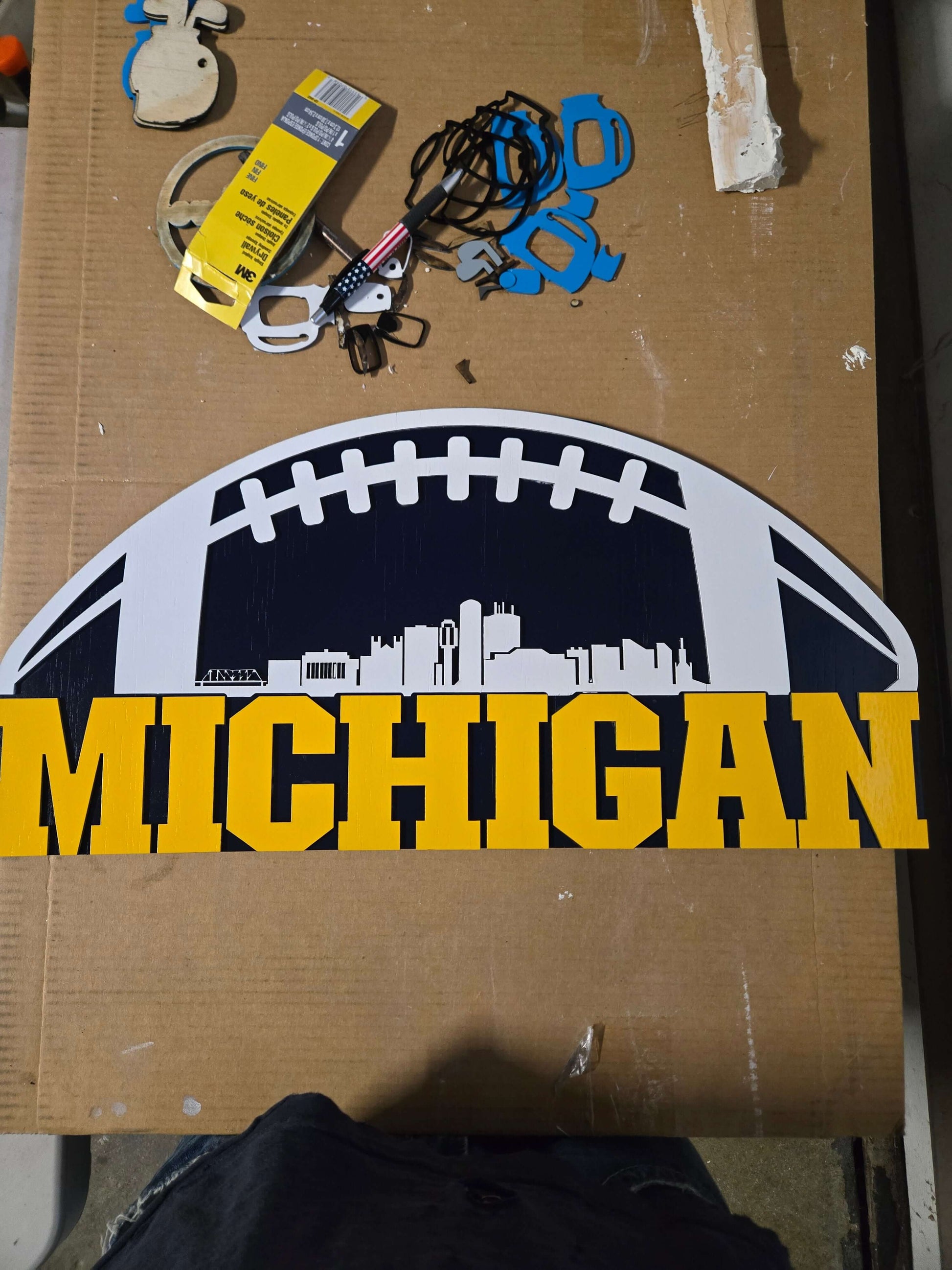 Michigan wooden decor sign featuring a city skyline and football design, perfect for Michigan football fans.