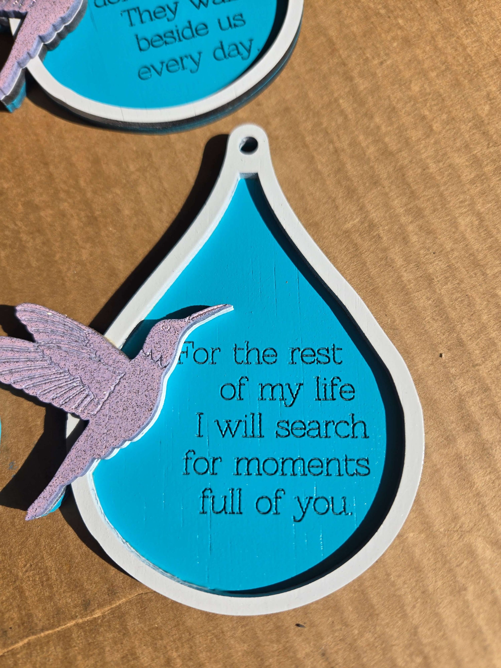 Humming bird Christmas ornament featuring a quote about searching for moments full of joy and love.
